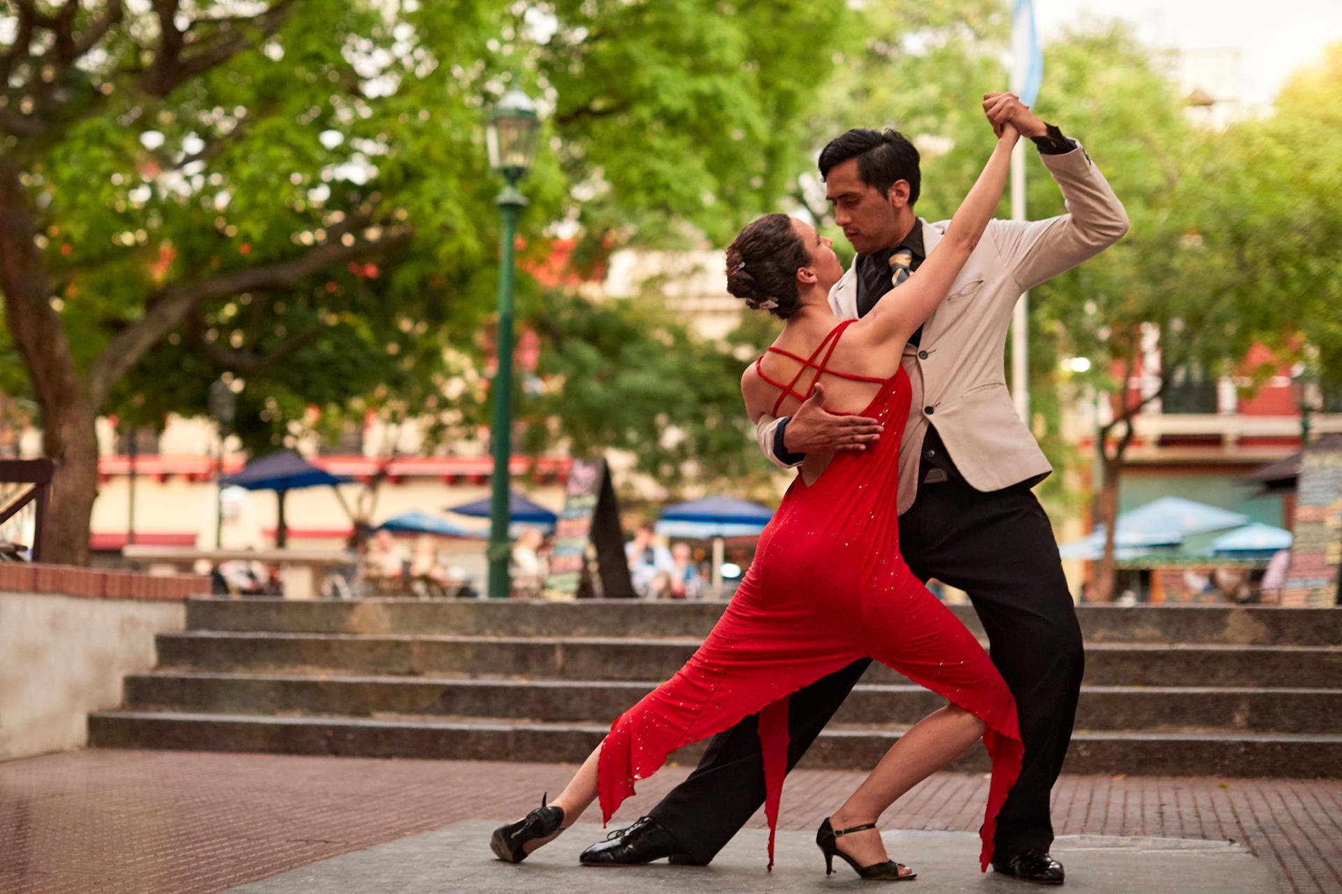 A couple dancing tango outdoors.